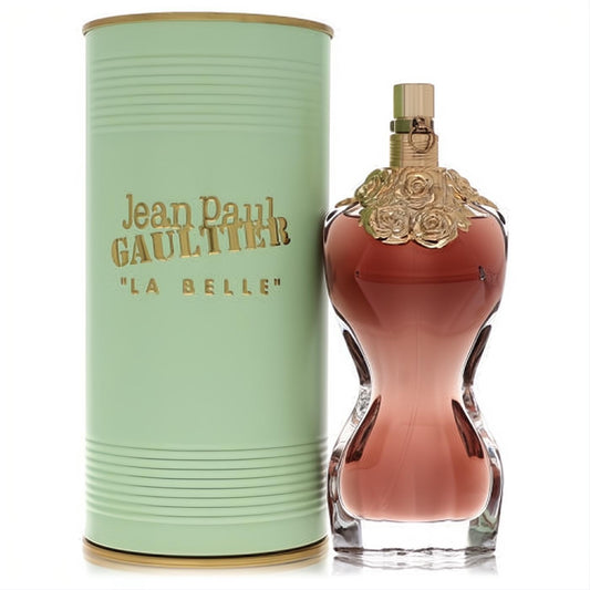 Jean Paul Gaultier La Belle women's perfume: iconic amber torso bottle with gold roses, beside a ribbed mint green canister.
