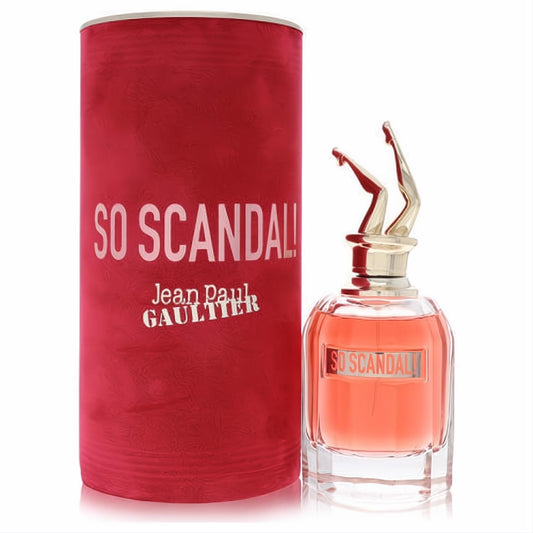 Jean Paul Gaultier So Scandal! 2.7 oz EDP. Daring clear bottle with peachy perfume, iconic gold leg cap, and vibrant red textured box.