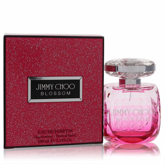 Jimmy Choo Blossom 3.3 oz Eau De Parfum. Luxurious pink glass bottle with a faceted crystal cap, next to its sparkling red glitter box.