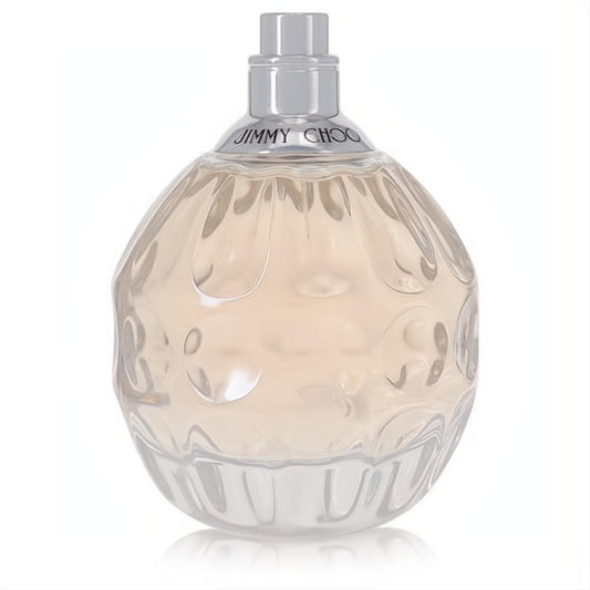 Elegant Jimmy Choo women's Eau De Toilette in a sculpted clear glass bottle with pale peach fragrance and sleek silver cap.