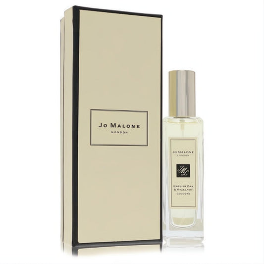 Luxurious Jo Malone English Oak & Hazelnut 1 oz cologne spray. Clear bottle, silver cap, elegant cream box.