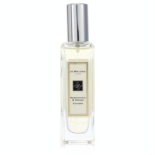 Luxurious Jo Malone Honeysuckle & Davana 1 oz cologne spray. Clear glass bottle, pale yellow liquid, shiny silver cap, and elegant cream label.