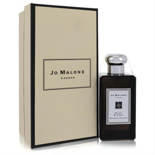 Jo Malone Myrrh & Tonka Cologne Intense unisex fragrance. Dark brown bottle with sleek silver cap, beside its elegant cream and black box.