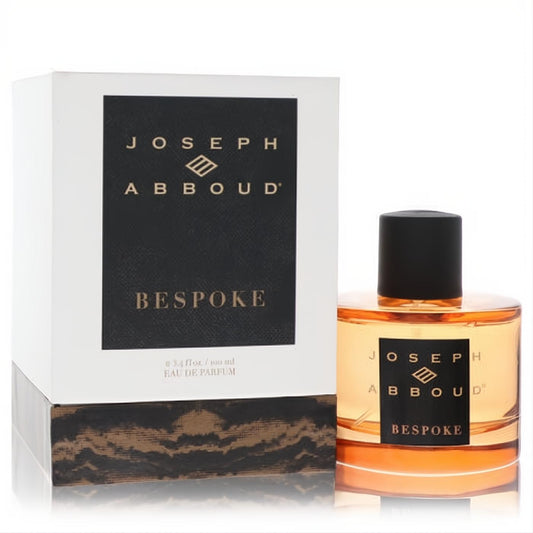 Joseph Abboud Bespoke 3.4 oz EDP. Amber fragrance in a clear glass bottle with black cap, next to its elegant white branded box.**