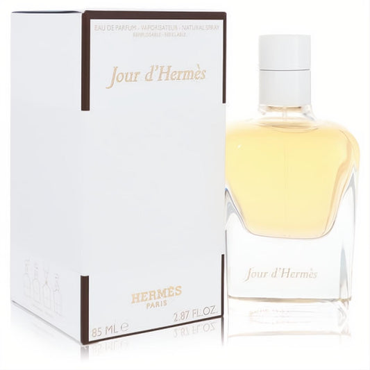 Jour D'Hermes 2.87 oz refillable Eau de Parfum in elegant sculpted clear glass bottle with golden liquid, beside its white box.