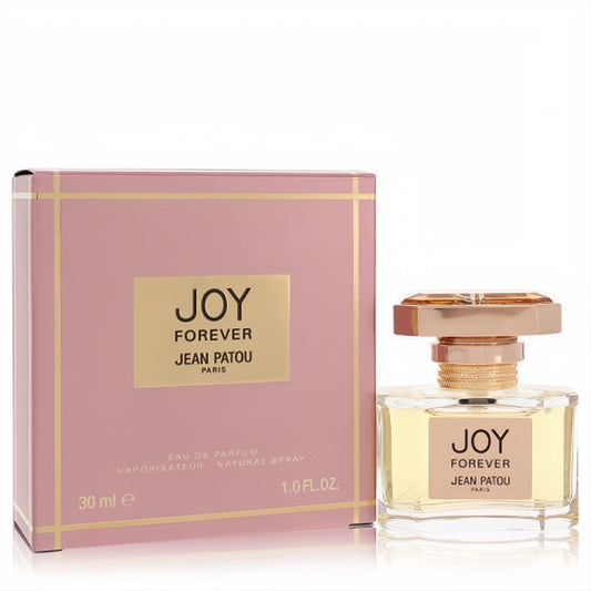 Luxurious Joy Forever Jean Patou 1 oz EDP spray. Clear bottle with ornate gold floral cap, beside its elegant pink and gold gift box.
