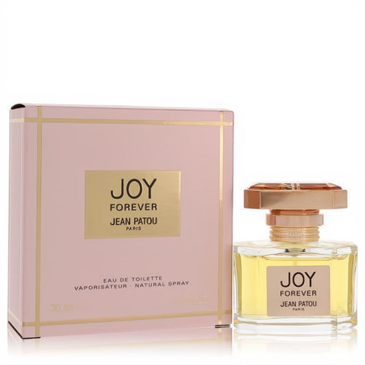 Joy Forever Jean Patou 1 oz EDT spray: clear bottle with golden liquid, geometric gold cap, and elegant blush pink box with gold trim.