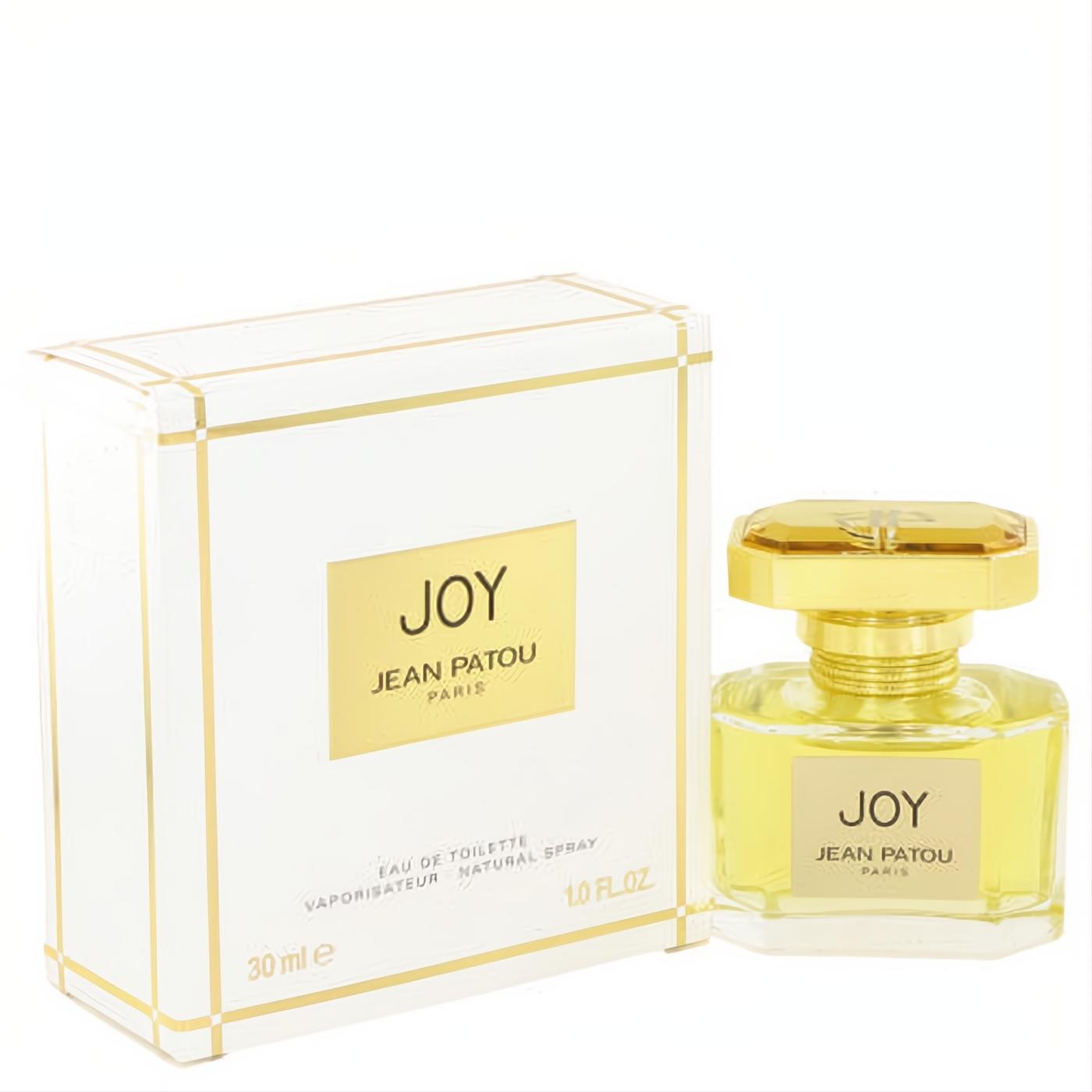Joy by Jean Patou 1 oz Eau De Toilette spray. Luxurious gold-capped bottle with golden liquid, beside its elegant white and gold box.