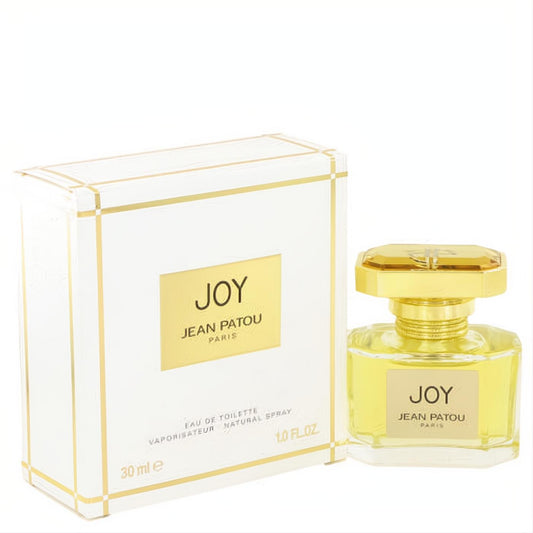 Joy by Jean Patou 1 oz Eau De Toilette spray. Luxurious gold-capped bottle with golden liquid, beside its elegant white and gold box.