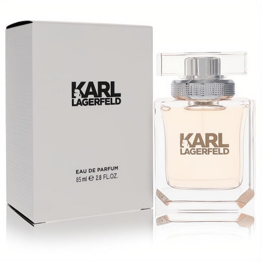 Elegant Karl Lagerfeld Eau De Parfum 2.8 oz spray. Clear glass bottle with a gentle peach hue, silver cap, alongside its crisp white box.