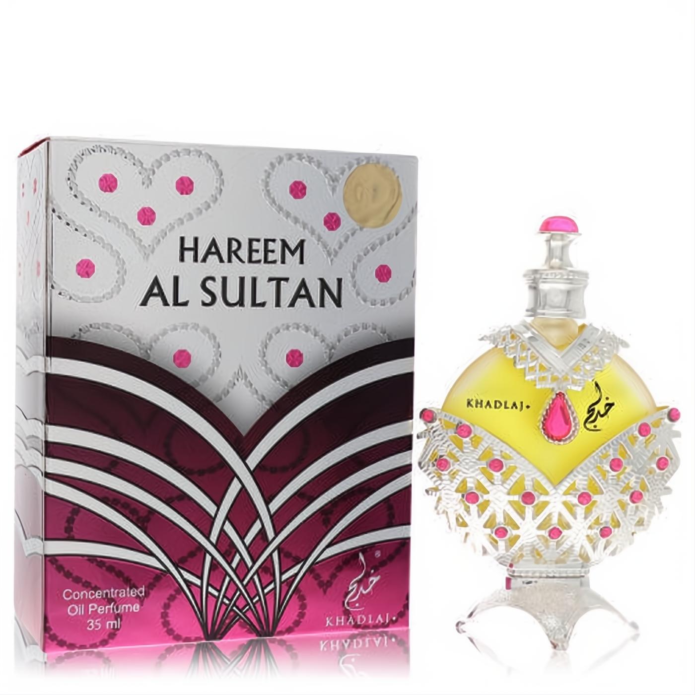 Exquisite Khadlaj Hareem Al Sultan Silver 1.18 oz perfume oil. Ornate silver bottle with yellow liquid, pink jewels, and decorative box.