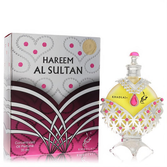 Exquisite Khadlaj Hareem Al Sultan Silver 1.18 oz perfume oil. Ornate silver bottle with yellow liquid, pink jewels, and decorative box.