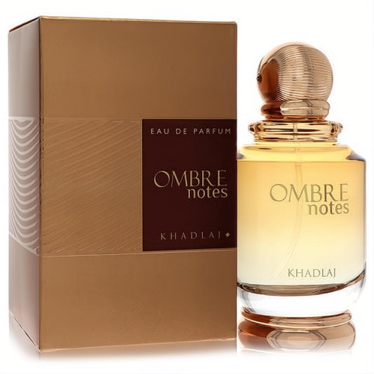 Khadlaj Ombre Notes 3.4 oz unisex EDP. Elegant clear bottle with a gold ribbed cap, beside its luxurious metallic gold box.