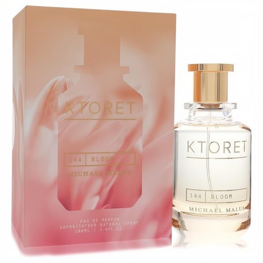 Experience Ktoret 144 Bloom 3.4 oz women's perfume: clear glass bottle, gold cap, and elegant peach floral box.