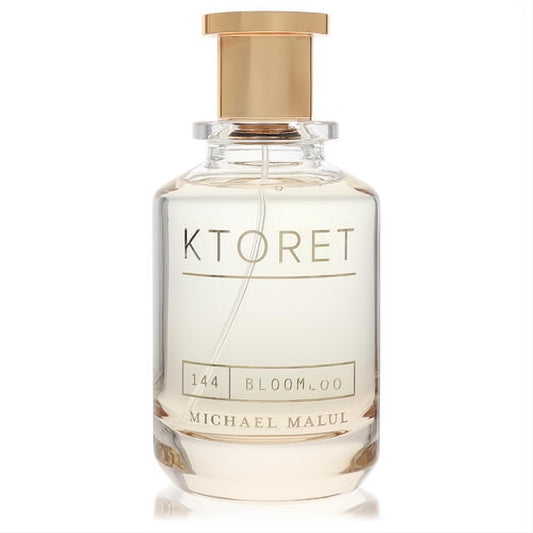 Elegant Ktoret 144 Bloom Michael Malul 3.4 oz women's perfume. Clear glass bottle, sleek design, and a radiant gold cap.