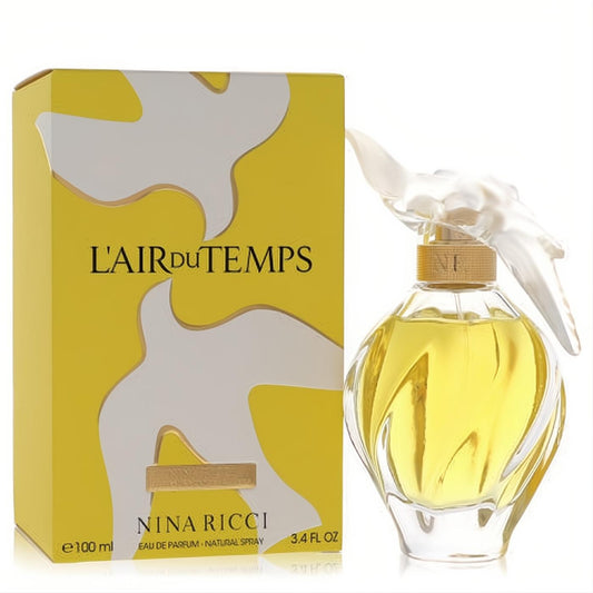 Elegant Nina Ricci L'Air Du Temps perfume in a swirled glass bottle with golden liquid, iconic white dove cap, and yellow box.