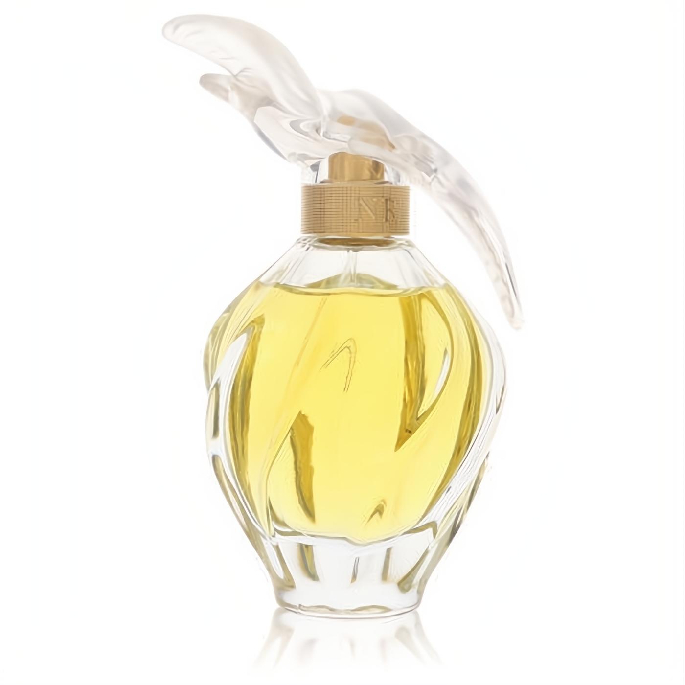 L'Air Du Temps Nina Ricci Eau De Parfum. Refined twisted glass bottle, golden liquid, and iconic clear dove cap.
