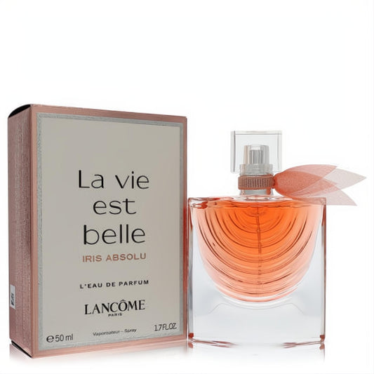 Lancome La Vie Est Belle Iris Absolu 1.7 oz Eau de Parfum. Clear bottle with warm amber liquid, delicate peach ribbon, and elegant rose gold box.