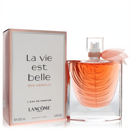 Lancome La Vie Est Belle Iris Absolu 3.4 oz EDP. Sculpted glass bottle with radiant amber liquid, pink bow, and chic rose gold box.