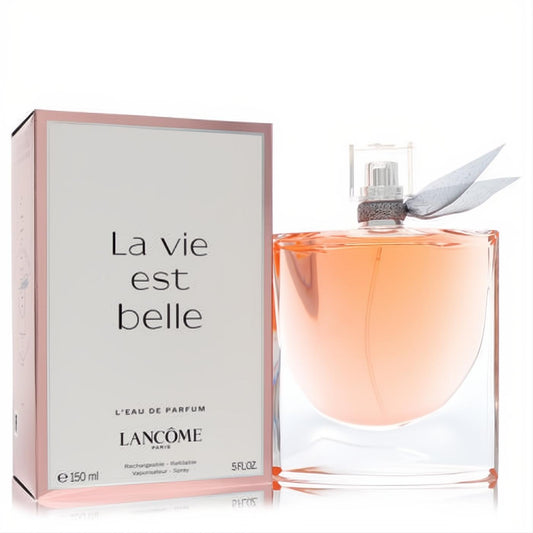 Lancome La Vie Est Belle 5 oz refillable Eau de Parfum. Elegant glass bottle with peach liquid, silver ribbon, and pink box.