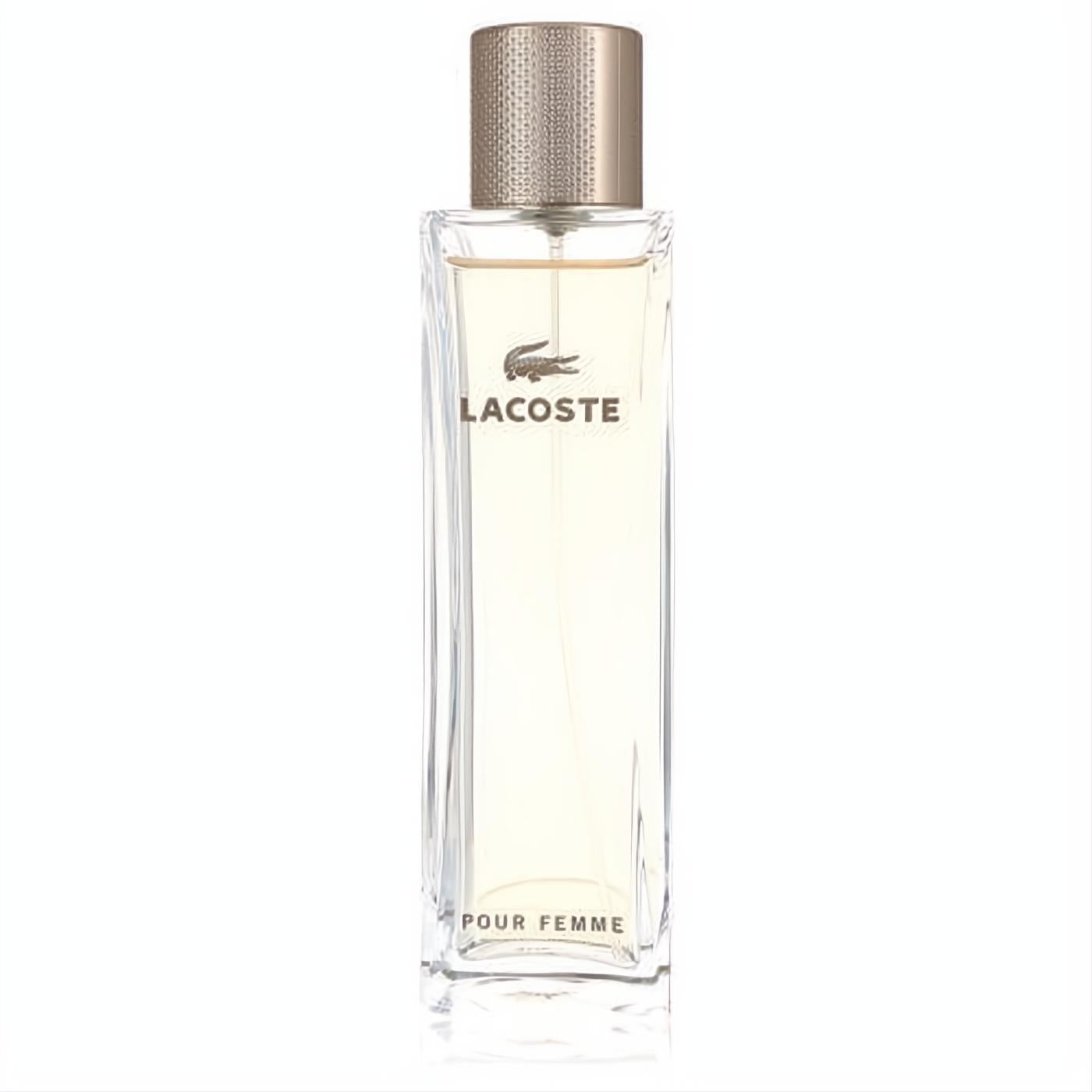 Elegant Lacoste Pour Femme Eau De Parfum spray. Clear glass bottle with light amber liquid, luxurious gold cap, and iconic Lacoste branding.