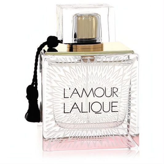 Discover Lalique L'Amour 3.3 oz EDP. Elegant clear glass bottle, delicate pink liquid, intricate floral design, gold cap, black tassel.