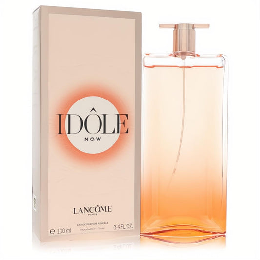Lancome Idole Now Florale 3.4 oz EDP. Stunning thin glass bottle with warm orange gradient and chic rose gold cap, beside its elegant peach box.