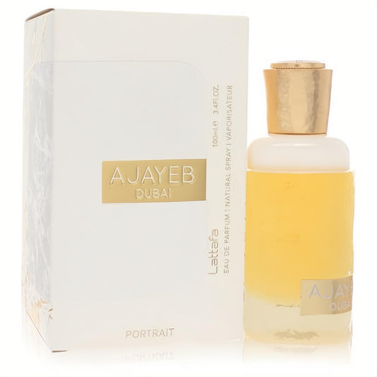Lattafa Ajayeb Dubai Portrait 3.4 oz unisex EDP. Golden fragrance in a sleek clear bottle with a matching elegant white and gold box.
