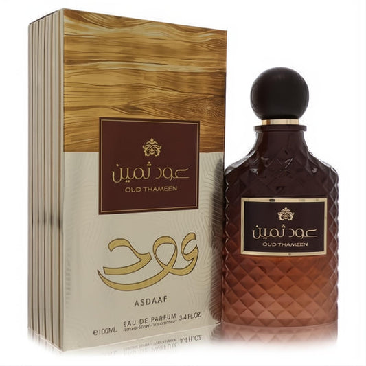 Premium Lattafa Asdaaf Oud Thameen 3.4oz unisex EDP. Unique brown faceted bottle, gold cap, and luxurious gold wood-grain box.