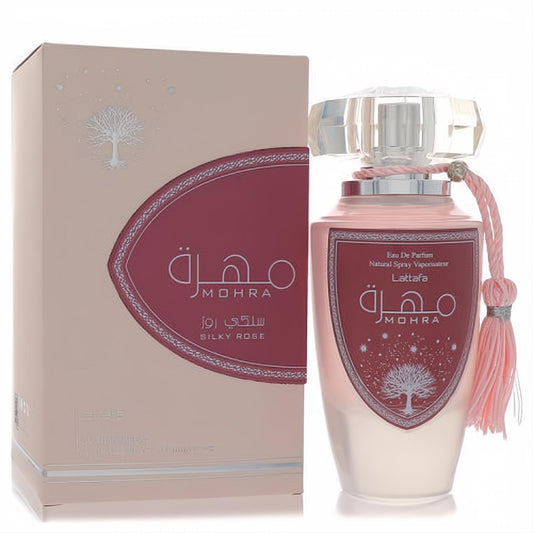 Elegant Lattafa Mohra Silky Rose perfume in a soft pink bottle with a crystal cap and pink tassel, beside its matching ornate box.
