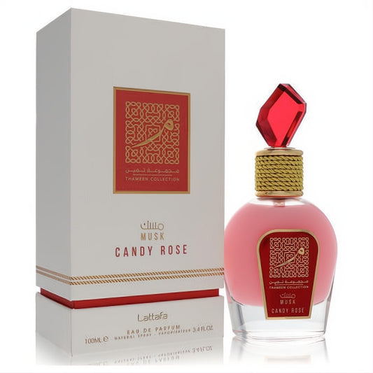 Luxurious Lattafa Musk Candy Rose 3.4 oz Eau De Parfum. Pink glass bottle, red faceted cap, gold braided neck, and elegant white box.