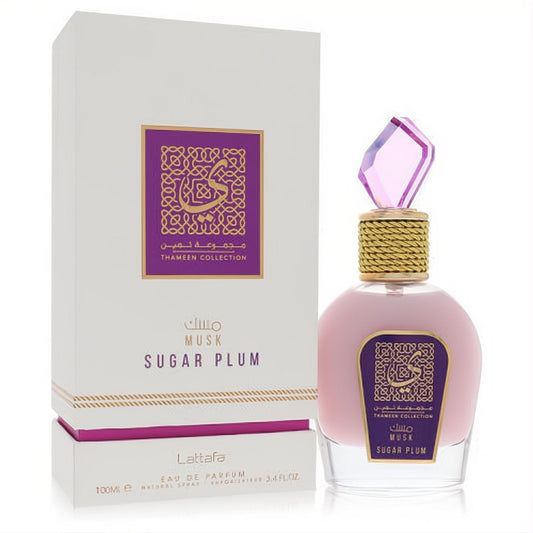 Lattafa Musk Sugar Plum 3.4 oz EDP. Luxurious pink bottle with a sparkling faceted purple cap, gold-wrapped neck, and elegant white box.