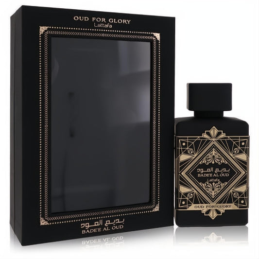 Luxurious Lattafa Oud For Glory Badee Al Oud 3.4 oz unisex EDP. Sleek black bottle with opulent gold art deco design, beside its elegant box.