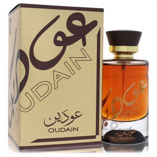 Elegant Lattafa Oudain 3.4 oz unisex EDP. Amber liquid in a clear bottle with gold script, dark cap, and matching gold box.
