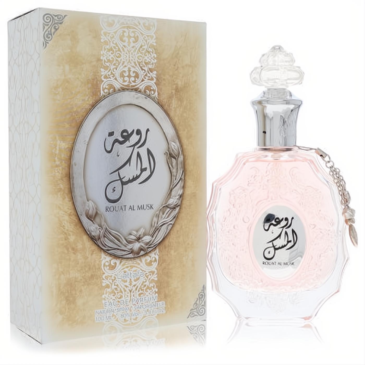 Lattafa Rouat Al Musk 3.4 oz unisex EDP. Elegant gold box & clear glass bottle with light pink fragrance, ornate silver cap, and chain.