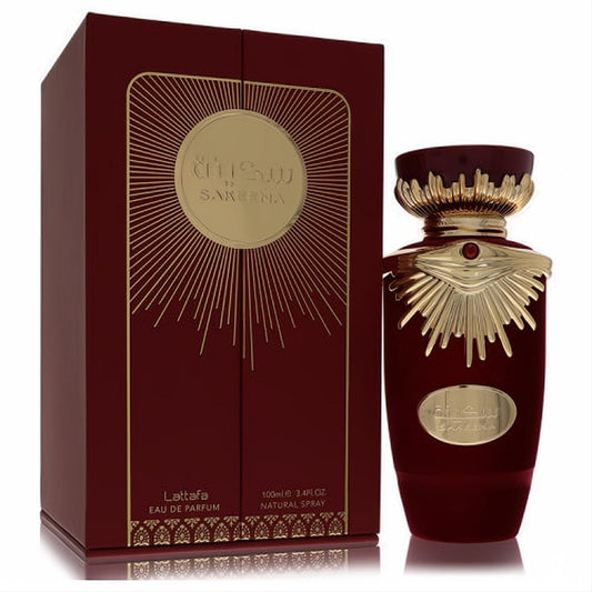 Lattafa Sakeena 3.4 oz unisex EDP. Rich burgundy bottle with ornate gold eye design and matching elegant gift box.