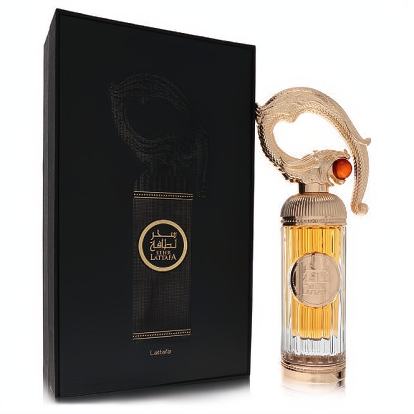 Stunning Lattafa Sehr 3.4 oz EDP. Ornate gold cap with amber jewel, fluted glass bottle, and elegant black box.
