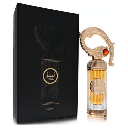 Stunning Lattafa Sehr 3.4 oz EDP. Ornate gold cap with amber jewel, fluted glass bottle, and elegant black box.