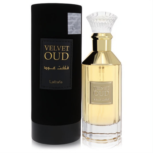 Luxurious Lattafa Velvet Oud 3.4 oz unisex EDP. Gold-accented ribbed glass bottle with faceted cap, beside its sleek black cylindrical box.