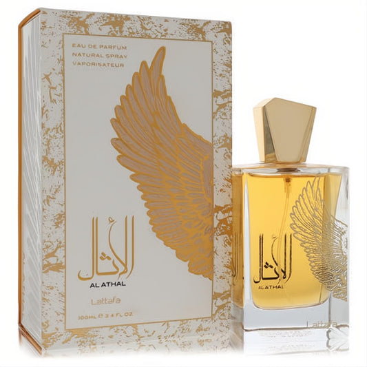 Lattfa Al Athal 3.4 oz unisex EDP. Luxurious clear bottle with golden liquid, elegant gold cap, and unique wing design on white box.