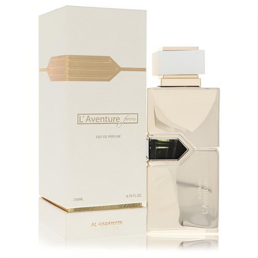 Experience L'aventure Femme 6.7 oz EDP: a luxurious gold metallic bottle with a sleek white cap, presented with its elegant cream and gold box.