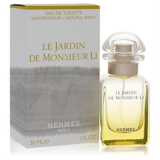 Hermes Le Jardin De Monsieur Li 1 oz EDT. Golden fragrance in a sleek glass bottle with a clear cap, next to its elegant white and gold box.