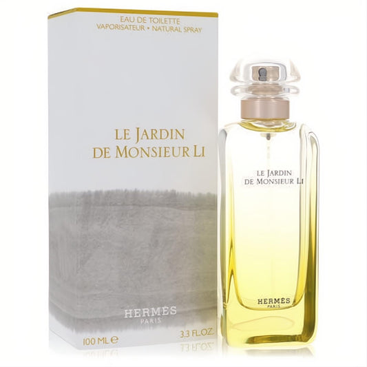 Vibrant Hermes Le Jardin De Monsieur Li 3.3 oz unisex EDT. Clear bottle with golden liquid, elegant white box with gold details.