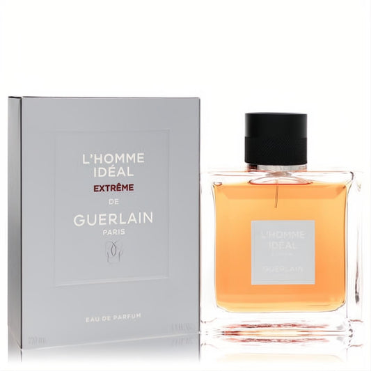 Sophisticated L'homme Ideal Extreme by Guerlain 3.3 oz Eau De Parfum. Clear glass bottle with amber liquid, black cap, and elegant grey box.