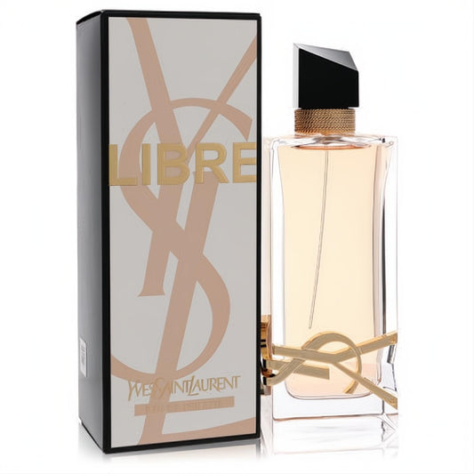 Indulge in Libre by YSL 3 oz Eau De Toilette. Clear bottle with iconic gold logo, elegant black cap, and amber liquid, beside its stylish box.