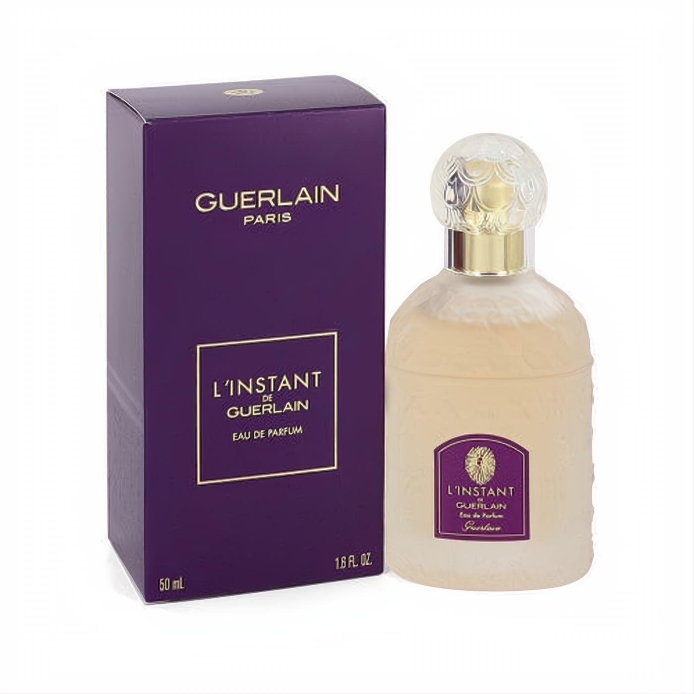 Luxurious L'instant de Guerlain 1.6 oz Eau de Parfum. Frosted glass bottle with sculpted floral cap and deep purple box.