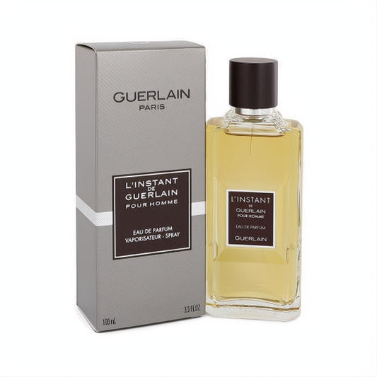 L'instant de Guerlain Pour Homme 3.3 oz EDP spray. Elegant clear glass bottle with dark cap, next to its sophisticated grey box.