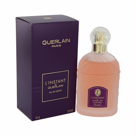 Exquisite L'instant de Guerlain 3.3 oz EDT. Frosted bottle with amber liquid, ornate gold cap, and a sophisticated dark purple box.
