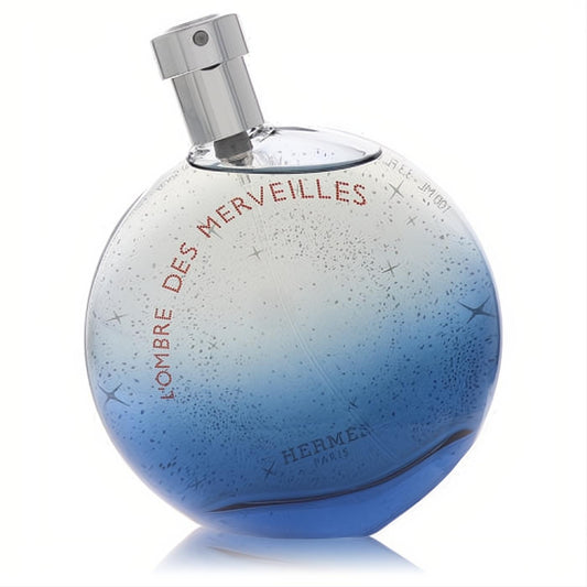 Hermes L'Ombre Des Merveilles 3.3 oz Eau de Parfum. Spherical blue gradient glass bottle, starry design, sleek silver sprayer.