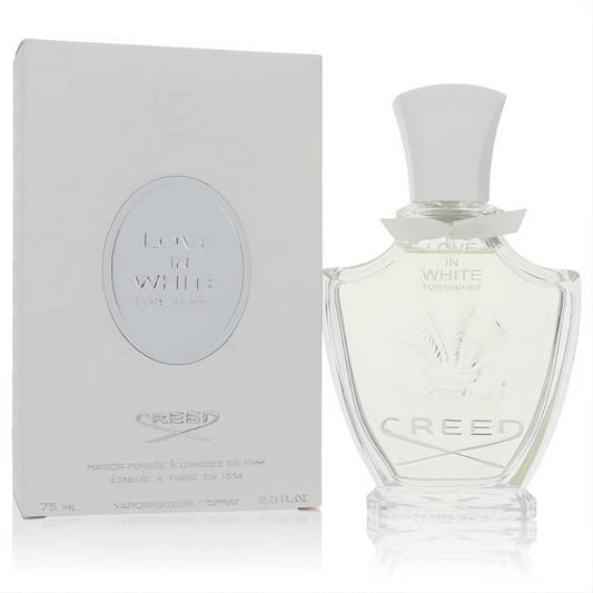 Luxurious Creed Love In White For Summer 2.5 oz EDP. Elegant clear glass bottle with white cap and leaf design, next to its pristine white box.